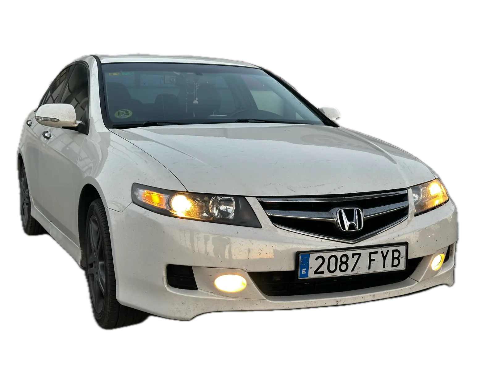 White Honda Accord with its headlights on